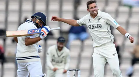 New Zealand's Tim Southee celebrates after dismissing India's Rohit Sharma