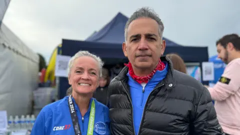 Sinead O'Malley Kumar and husband Sanjoy at the finish line of the Nottingham's half marathon.