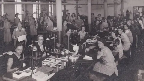 Dozens of women sitting at sewing machines making clothes at the Burton factory in Goole