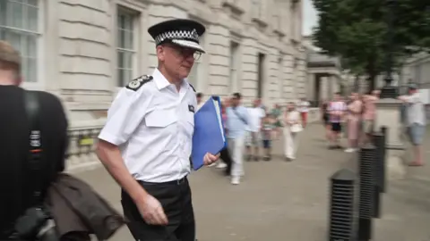 Sir Mark Rowley walks out of the Cabinet Office building