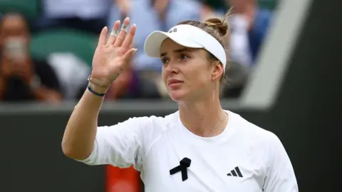 Reuters Ukraine's Elina Svitolina wearing a black ribbon while playing at the Wimbledon tennis on Monday