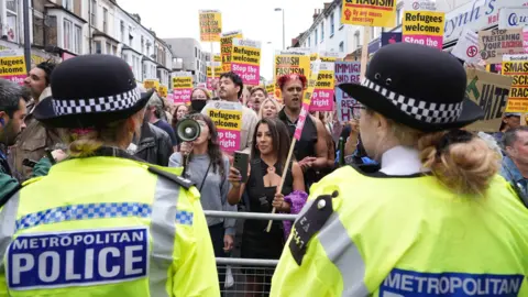 Demonstrators and police officers at an anti-racism protest in Walthamstow, London