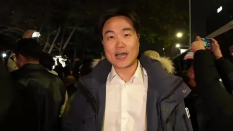 Jake Kwon in a crowd at night