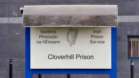 Cloverhill prison sign with harp and Irish Prison Service sign