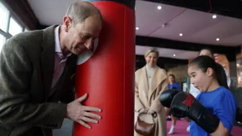 The Duke of Edinburgh holding a punchbag