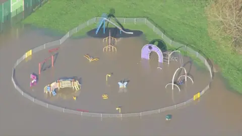 An aerial shot of a playground in Bradford-on-Avon submerged in floodwater