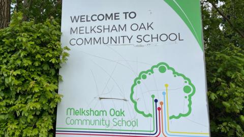 Melksham Oak Community School sign in a hedge