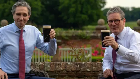 Prime Minister Sir Keir Starmer (right) and Taoiseach Simon Harris drink a pint of Guinness during his visit to Chequers
