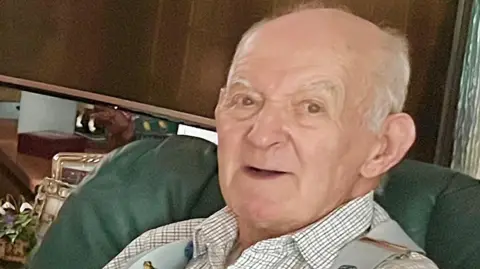 Bedfordshire Police Photo of Paul Swales, an elderly man wearing a white shirt and smiling at the camera.