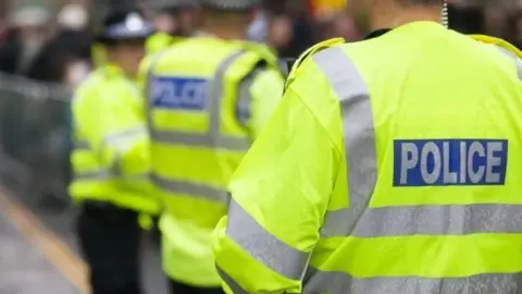 Stock image of police officers wearing hi-vis jackets.