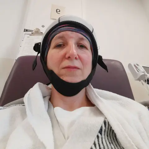 Nichola Rutherford Nichola wearing cold cap in chemo ward