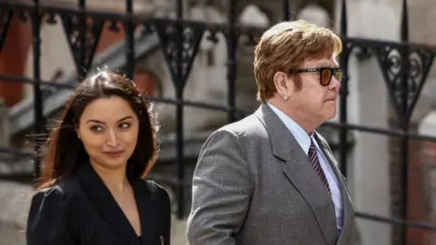 Reuters Sir Elton John wearing sunglasses on his way into the High Court on Monday