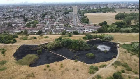 LFB Parkland with a big blackened patch, near homes including a tower block