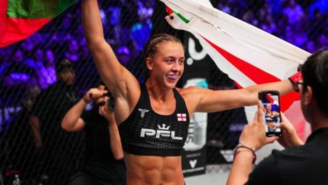 Dakota Ditcheva celebrates in the cage