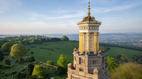 Casper Farrell The Beckford Tower near Bath with green fields behind it and a clear blue sky