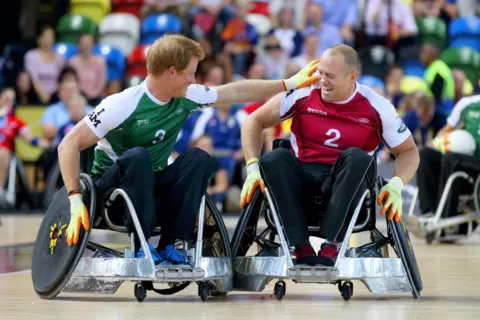 Getty Images Prince Harry and Mike Tindall competing in a wheelchair rugby match in 2014, London