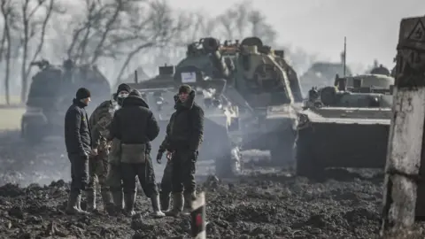 EPA Russian servicemen and armoured vehicles stand on the road in Rostov region, Russia