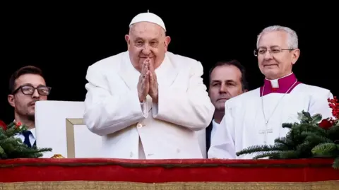 Pope Francis gestures from the balcony of St Peter's Basilica at the Vatican (25/12/24)