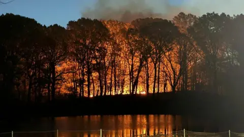 Smoke and orange embers billow from a fire at Prospect Park, New York City, New York, U.S., November 8, 2024