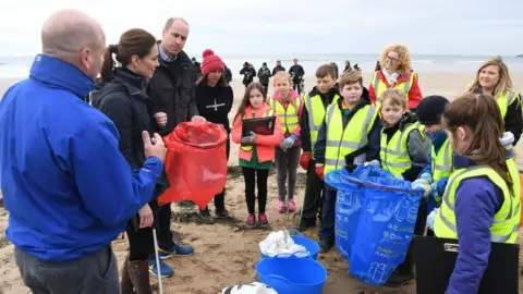 Getty Images Prince William and Catherine join primary school pupils in a beach clean-up on Newborough Beach, during a visit to Anglesey on 8 May 2019