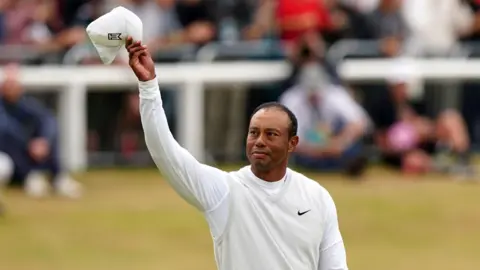 PA Media Tiger Woods acknowledges the crowds at the Open in 2022 