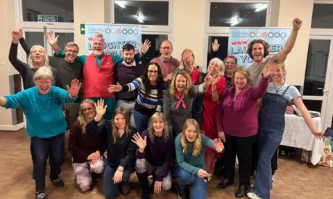 Clive St James A group of participants taking part in a laughter yoga class