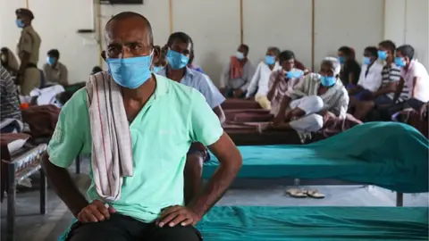 Getty Images A homeless person waits to be vaccinated with a dose of Covishield Vaccine at the homeless shelter, Yamuna Pushta near Nigambodh Ghat cremation ground. India has reported 40 cases of Delta Plus variant also known as AY.1, found in Maharashtra, Kerala and Madhya Pradesh. This variant also been seen in nine other countries of the world with 205 infections detected in Europe, America and Asia. (Photo by Naveen Sharma/SOPA Images/LightRocket via Getty Images)