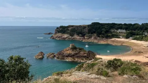 BBC Portelet - a beach and rocky shore with calm sea