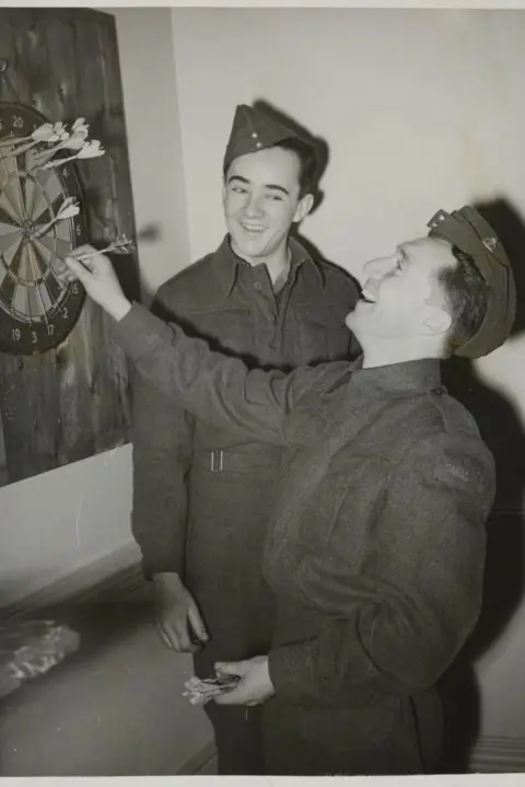 Getty Images Two Canadians at a darts board at the Beaver Club