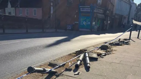 Bollards knocked down in Fye Bridge Street, with takeaway shop and Wensum Street in background