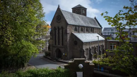 MANX SCENES The exterior of St Thomas' Church, the brown brick building is on the corner of a street.