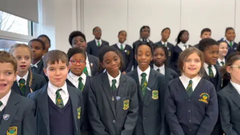 Children from St James the Great school sing their Christmas song