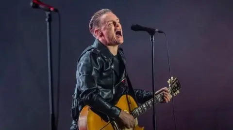 Canadian musician Bryan Adams performing at a concert in India