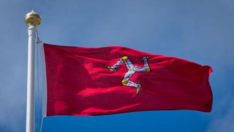 A Manx flag blowing in the wind