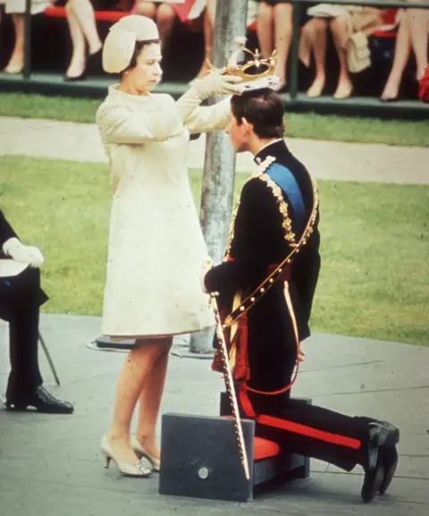 Getty Images Queen Elizabeth II crowns her son Charles, Prince of Wales, during his investiture ceremony at Caernarvon Castle. 1969