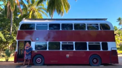 Kim and Ted in front of the bus