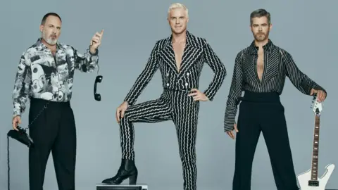 The Scissor Sisters pictured with a guitar, telephone and television set. Left to right: Babydaddy, Jake Shears and Del Marquis