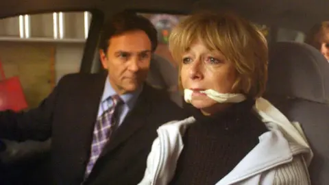 ITV Gail looking frightened in a car while being kidnapped along with her family by her third husband Richard Hillman