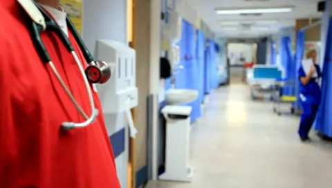 PA Media Person on a hospital ward with a stethescope