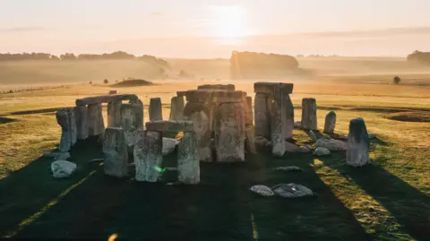 A view of Stonehenge on a sunny and misty morning