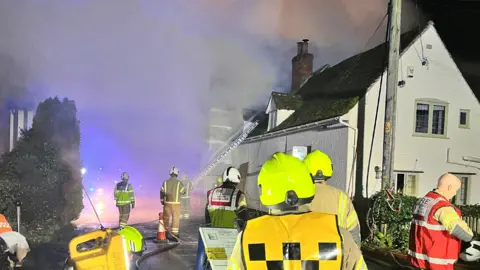 Smoke billows from house fire.