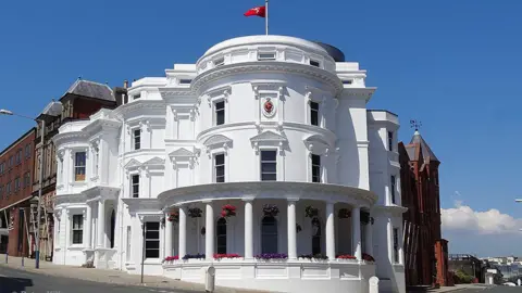 MANX SCENES The Isle of Man's parliamentary buildings. Known as the Wedding Cake building, it is a round, white three-tiered building.