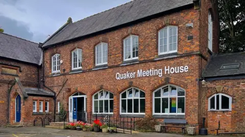 LDRS The red brick Quaker Meeting House in Sale, a two-storey building. 