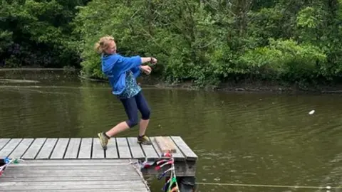 Christina mid throw at the Welsh stone skimming championships