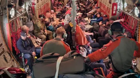 Canadian Armed Forces  Evacuees from Fort Smith crowd into a military aircraft during an airlift