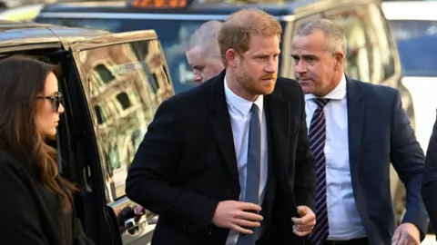 Reuters Prince Harrying getting out of a car as he arrives at the High Court on Monday