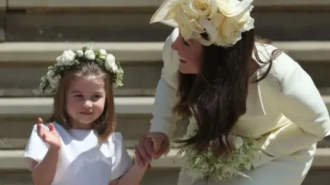 Getty Images Princess Charlotte waves to the crowds, as she holds her mother, the Duchess of Cambridge's, hand