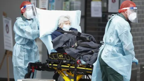 EPA A resident of the Epping Gardens Aged Care Facility is taken away in an ambulance in Epping, outskirts of Melbourne, Australia