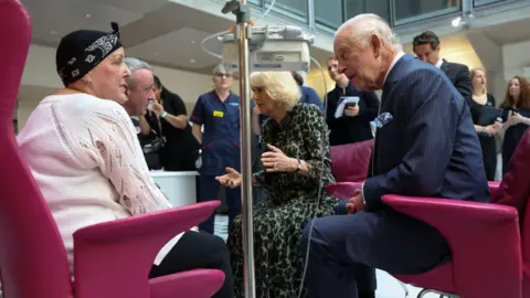 PA Media The King and Queen met cancer patient Lesley Woodbridge, who is receiving her second round of chemotherapy