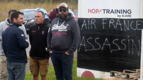 Getty Images Protestors at the entrance of an airport in Morlaix, western France